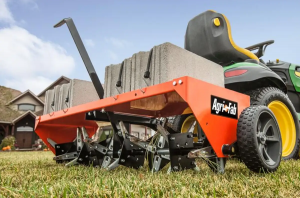 tow-behind aerator attached to lawn mower