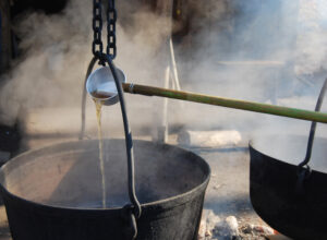 person boiling maple syrup
