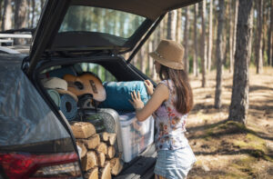 woman unloading car at campsite