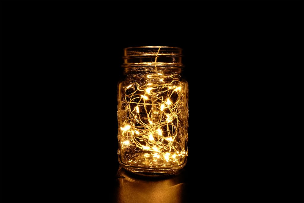 A picture of a mason jar filled with battery-operated LED lights.