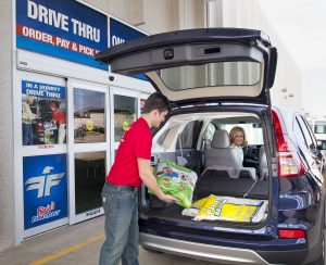Associate helping customer at drive thru pick up