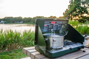 Camping stove with pot on a picnic table