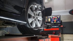 Car in shop getting a wheel alignment