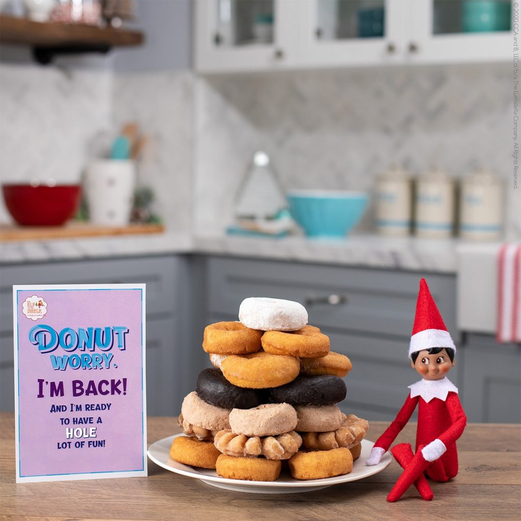 elf next to donuts
