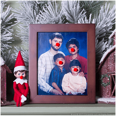 elf wearing clown nose next to picture with clown noses
