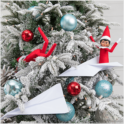 elves in paper airplanes on Christmas tree