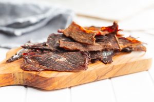 beef jerky on wood cutting board