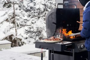 man grilling in winter