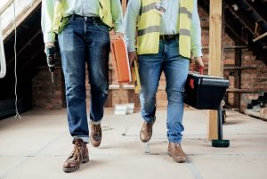 two construction workers wearing jeans
