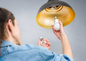 woman changing lightbulb