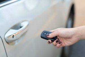 woman holding car key fob