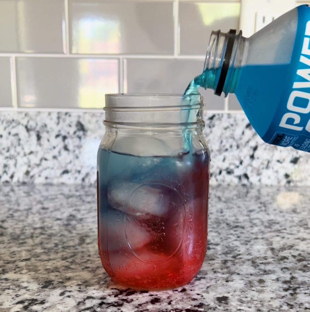 adding blue sports drink to mason jar