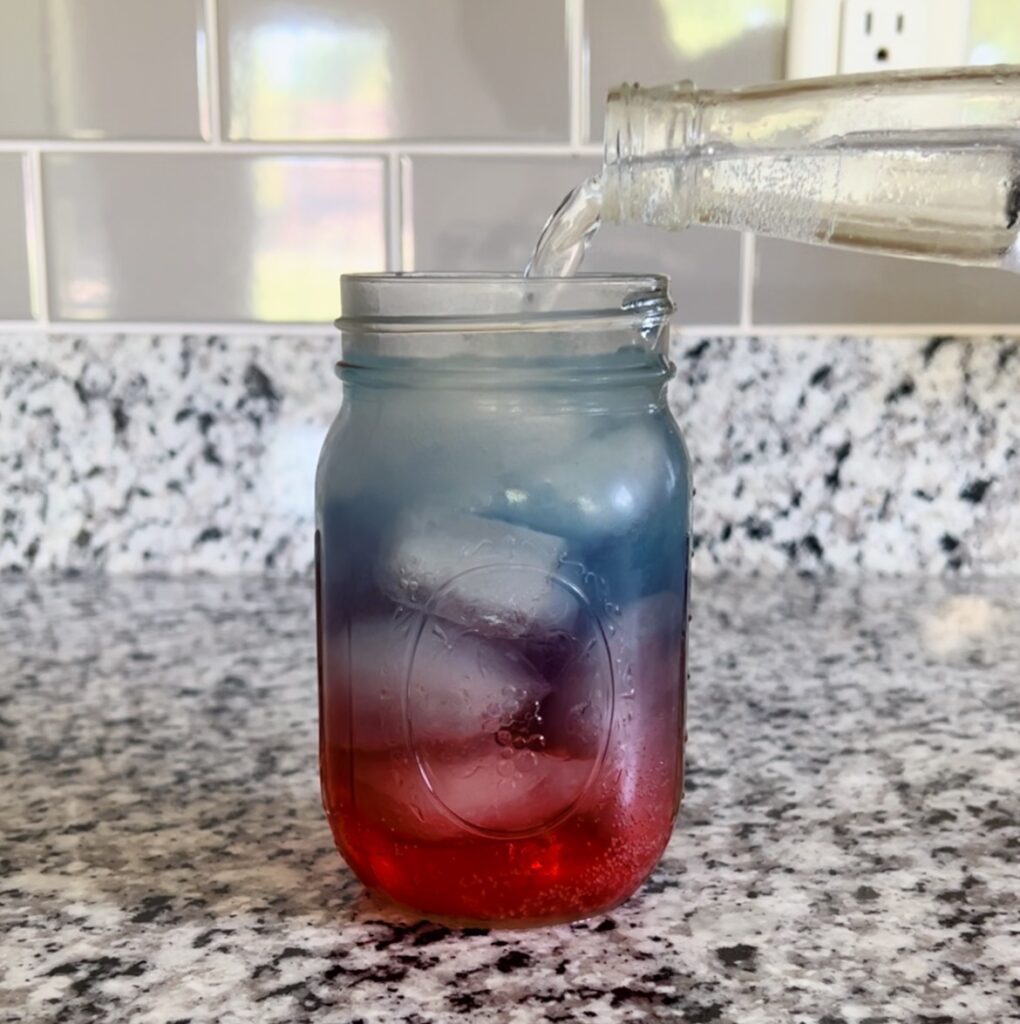 adding carbonated water to mason jar