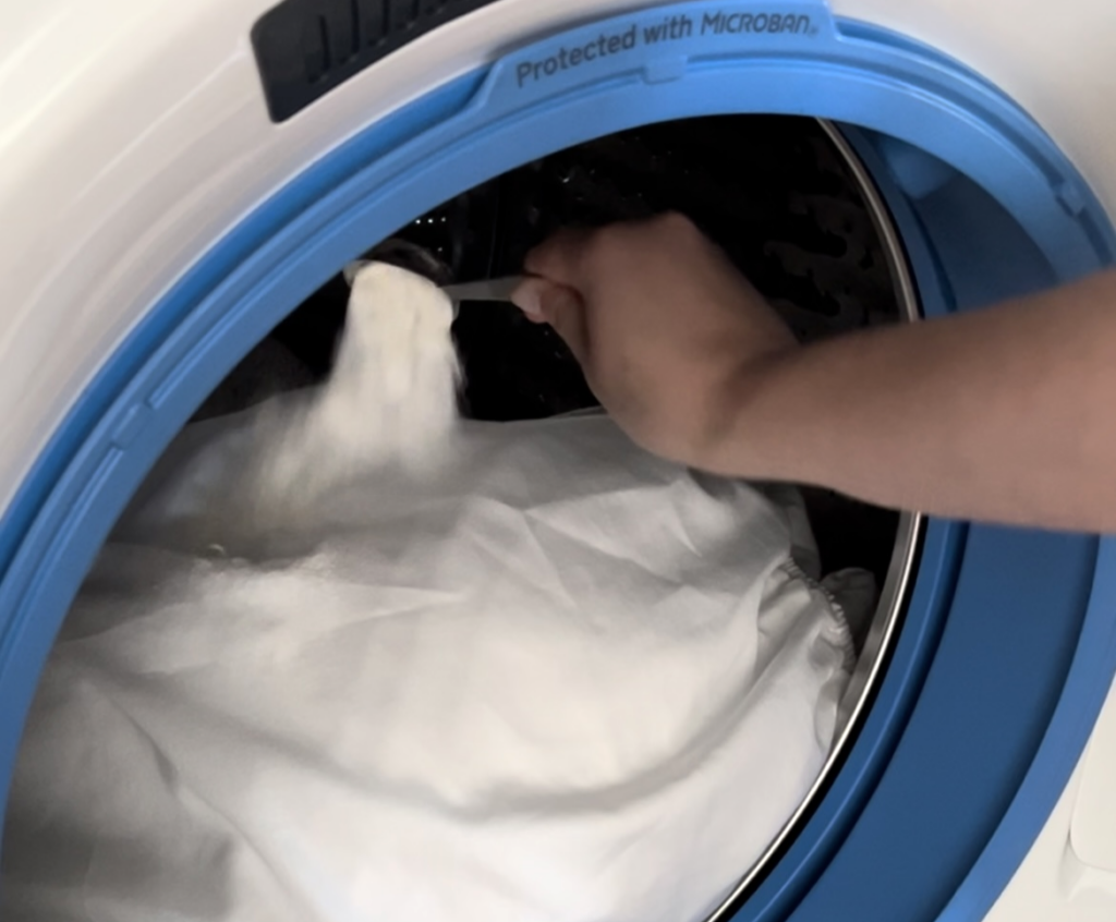 adding detergent to washer