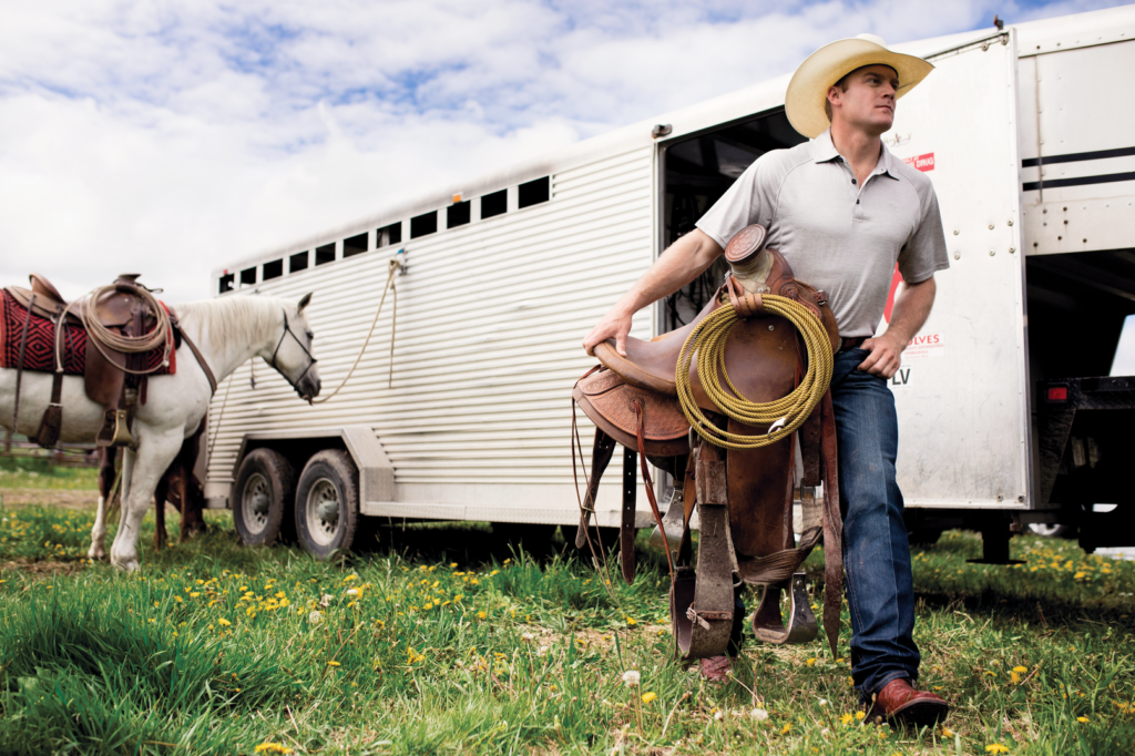 cowboy carrying saddle 