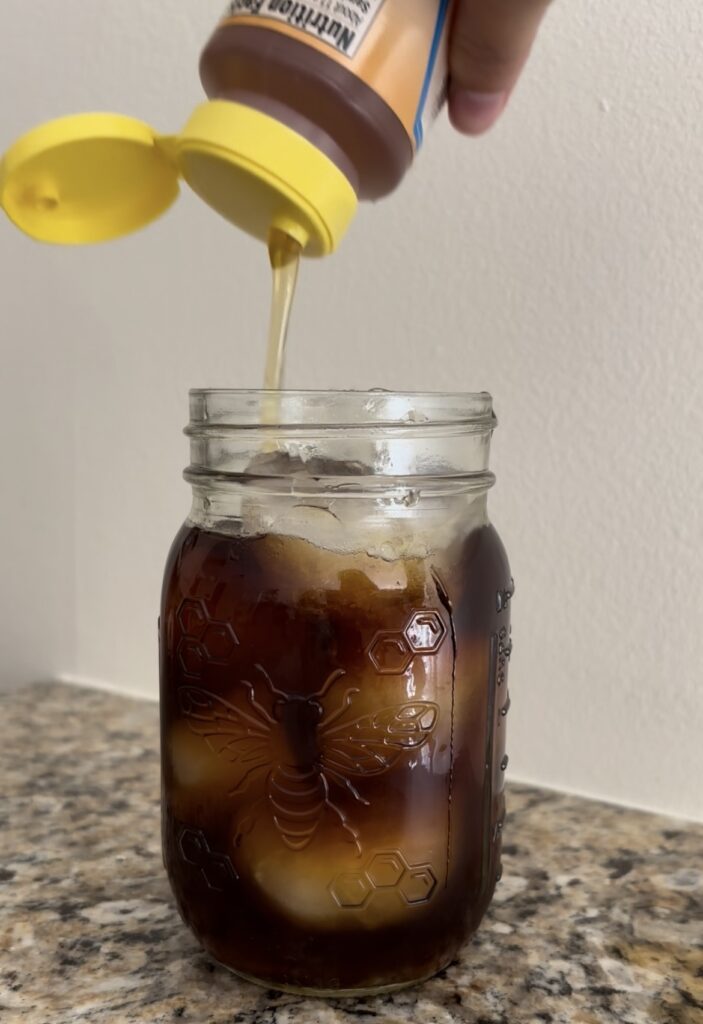 Adding honey to coffee