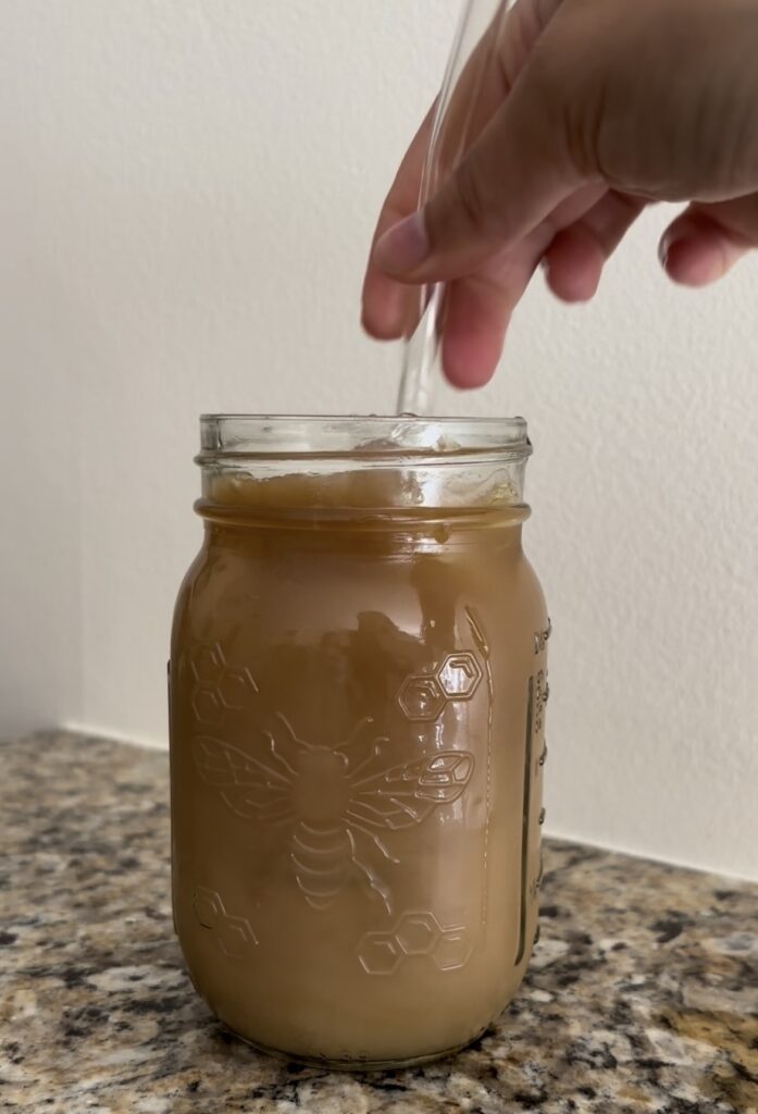 mixing iced coffee with straw