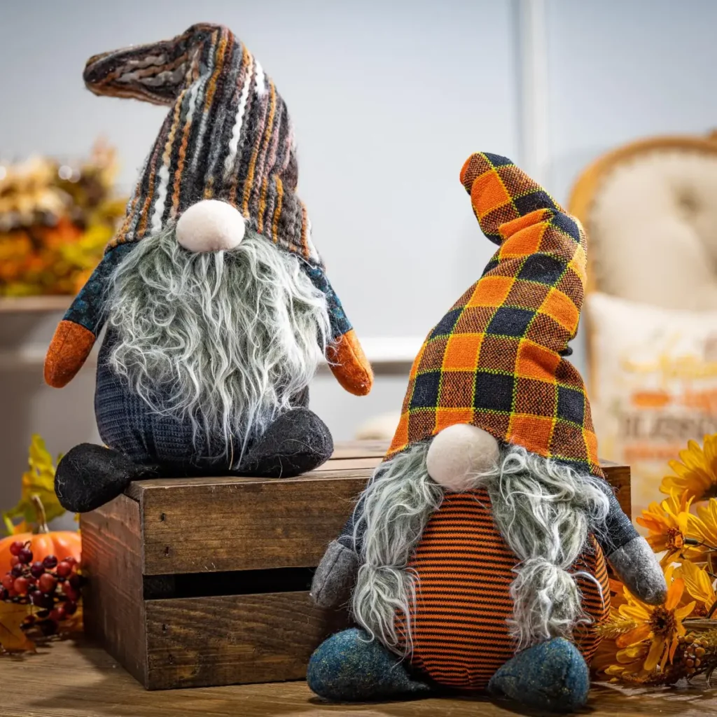 two Halloween gnomes on table next to other fall decor