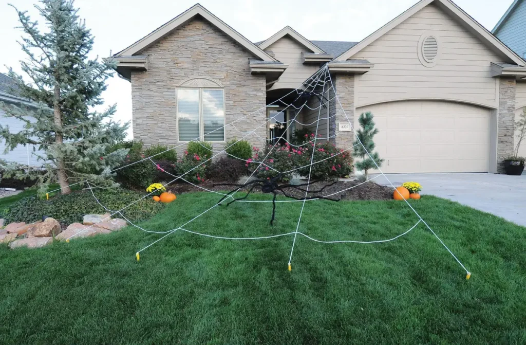 giant spider web decoration in front of house