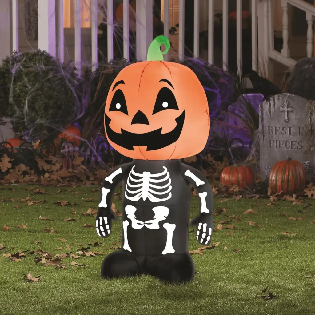 pumpkin skeleton inflatable Halloween decoration on front lawn