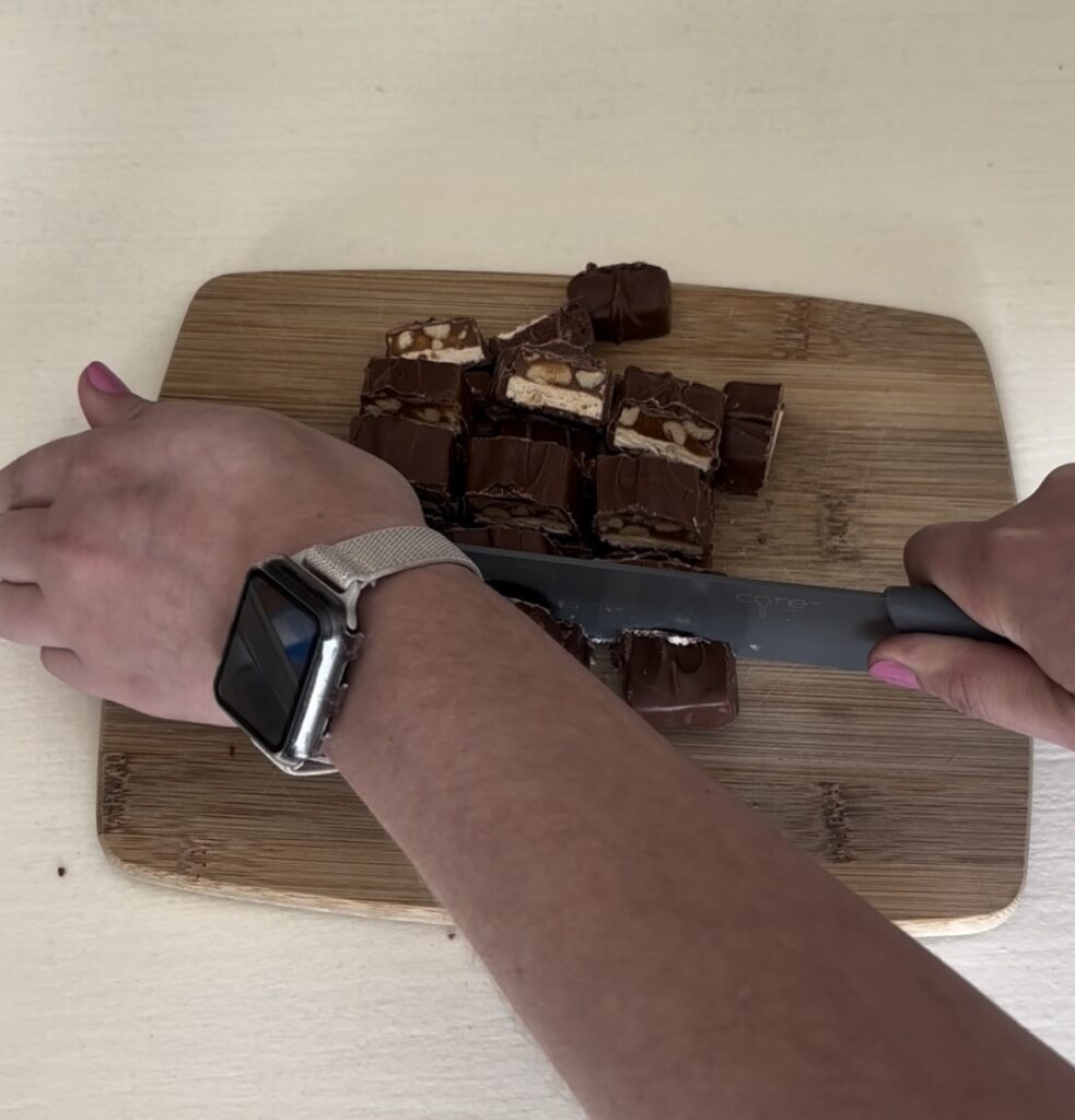 chopping Snickers bars