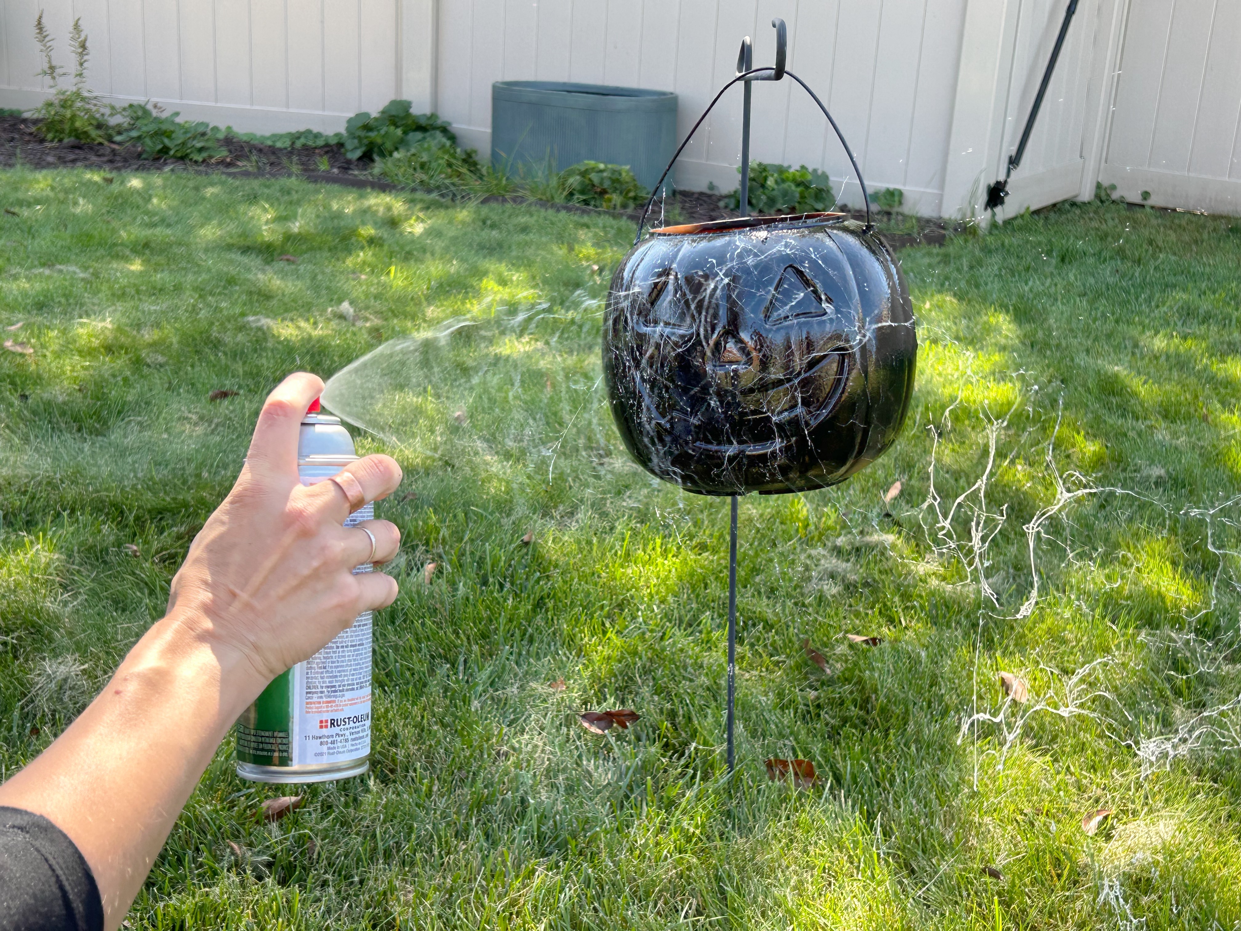 spray painting white marbling onto plastic pumpkin