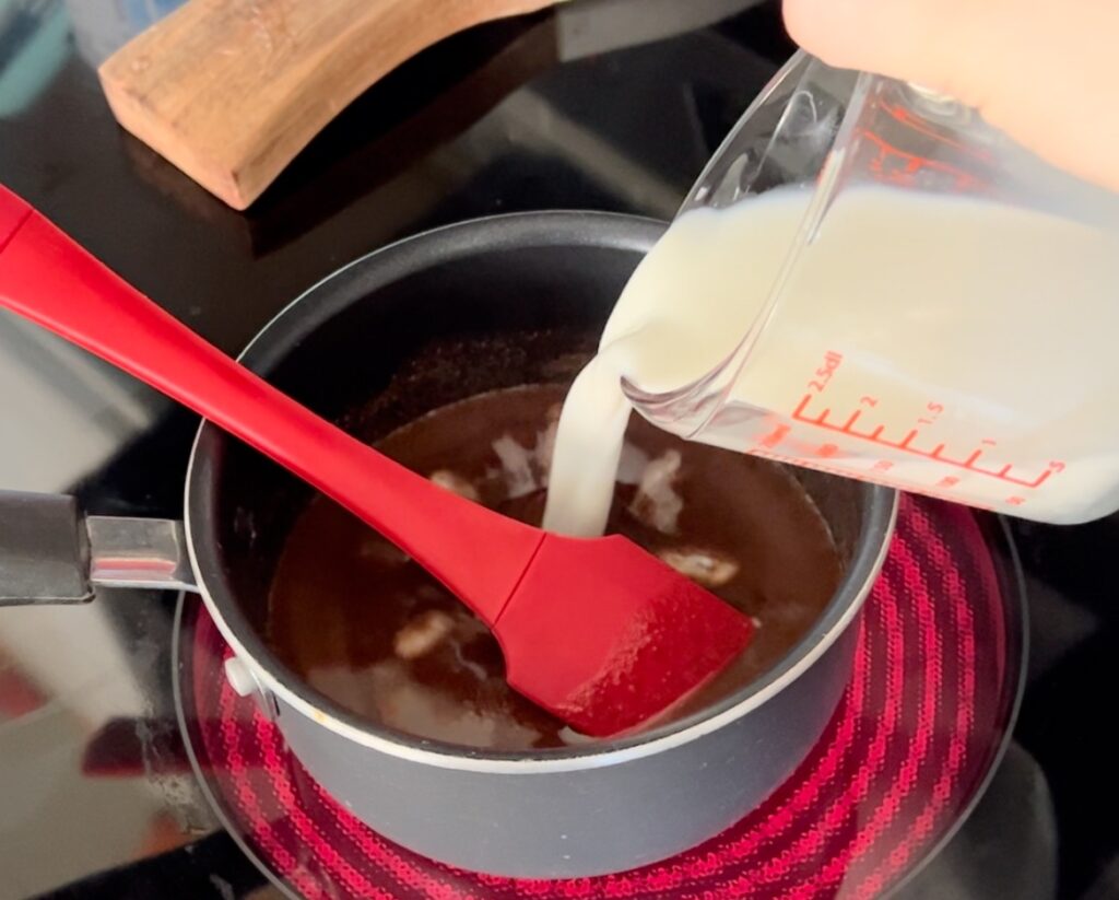adding milk to fudge mixture
