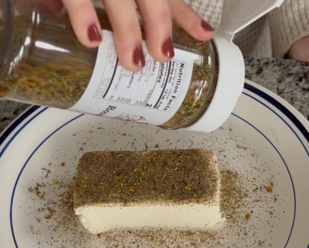 sprinkling seasoning on cream cheese