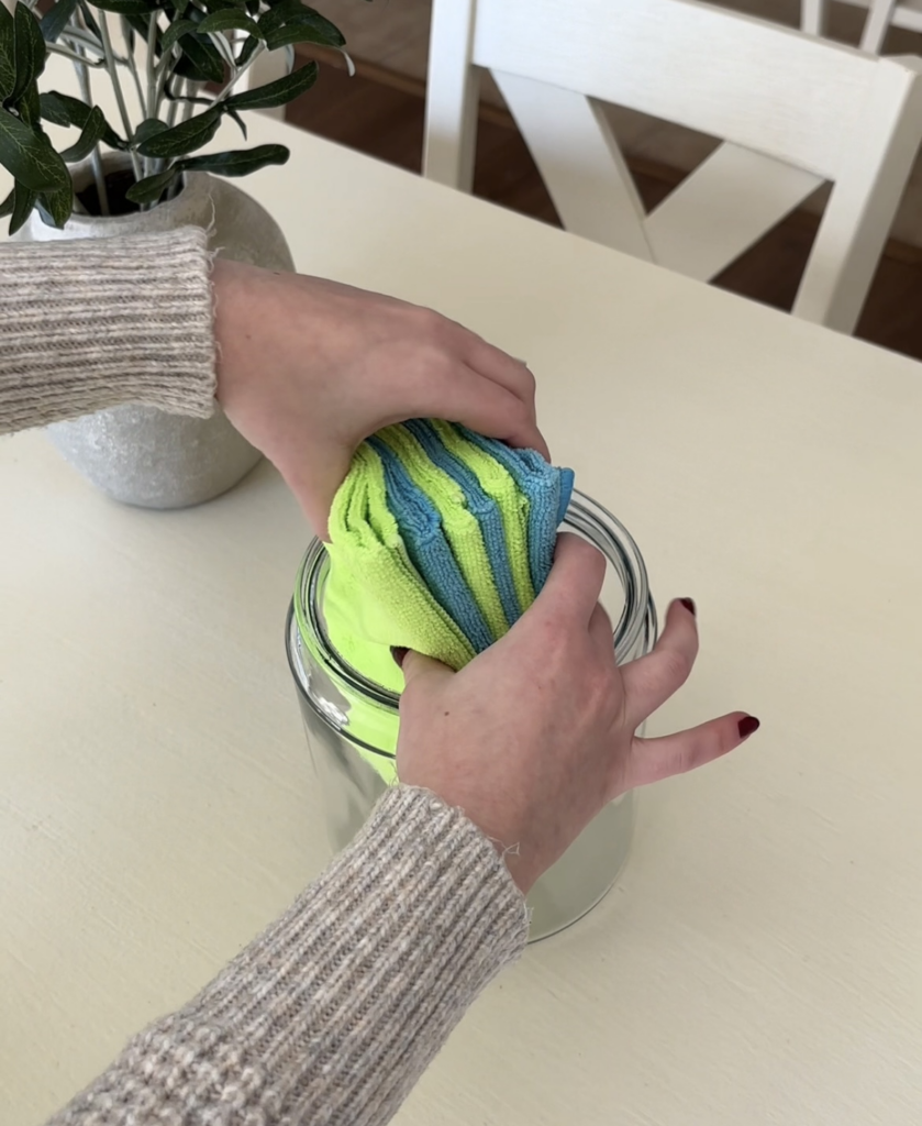 adding cloths to glass container