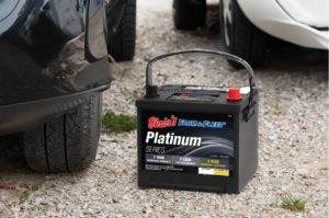 Blain's Farm & Fleet auto battery on road next to two cars