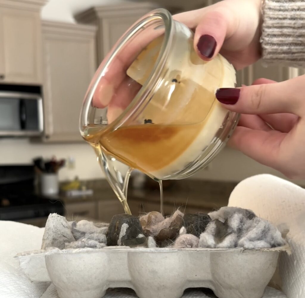 pouring candle wax in egg carton