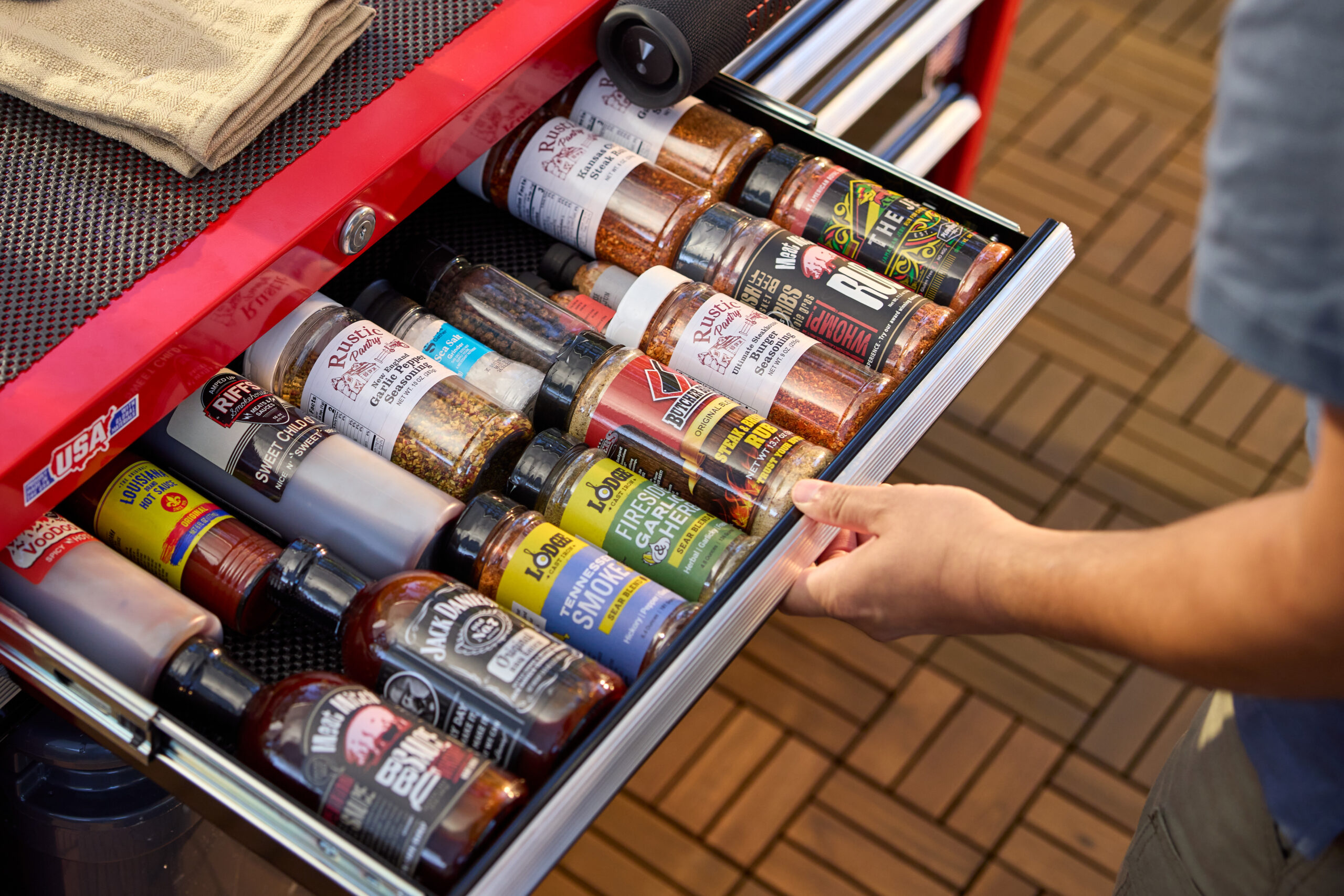 tool chest drawer filled with grill sauces and seasonings