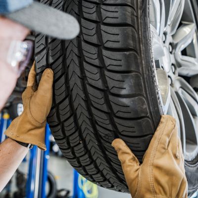 person changing tire on a car