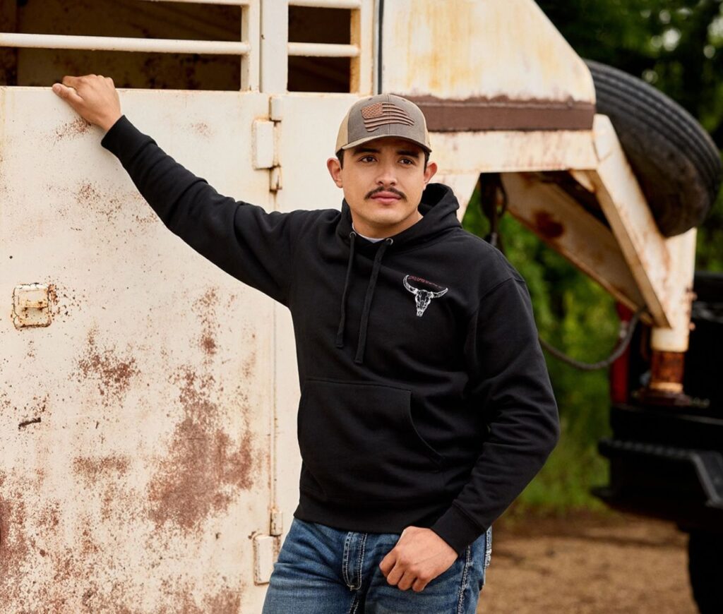 Farmer holding on to horse trailer